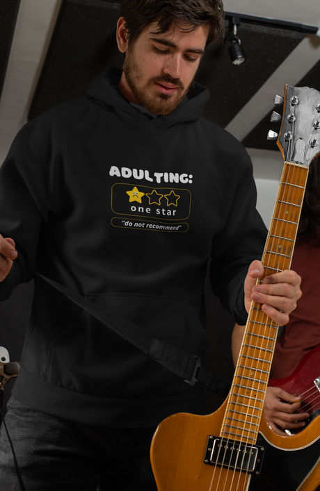 Adulting Unisex Heavy Blend Hoodie with one star "do not recommend" design, worn by a person playing guitar.