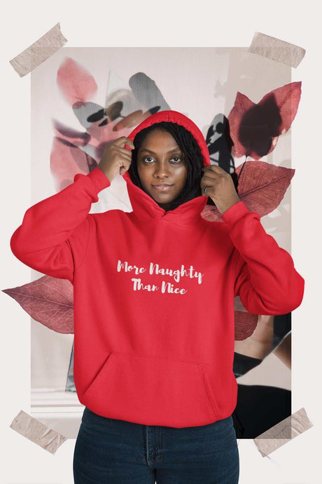 More Naughty Than Nice Unisex Heavy Blend Hoodie in red, featuring cotton-polyester blend, front kangaroo pocket, and matching drawstring.