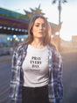 Funny women's t-shirt with "Pray Every Day" text in a casual outdoor setting.