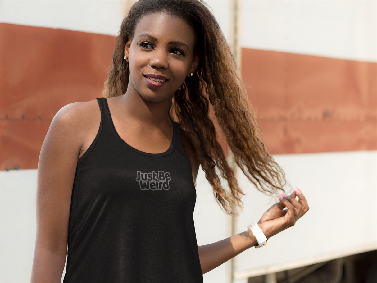 Dark women's racerback tank with "Just Be Weird" slogan, made of lightweight cotton and polyester blend for reduced shrinkage.