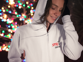 Unisex white zip-up hoodie with "Spirit Lead Me" design next to holiday lights.